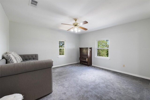 sitting room with a ceiling fan, carpet flooring, and baseboards