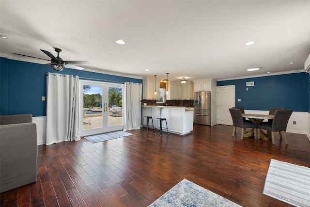 living room featuring crown molding, french doors, a ceiling fan, dark wood-style flooring, and recessed lighting