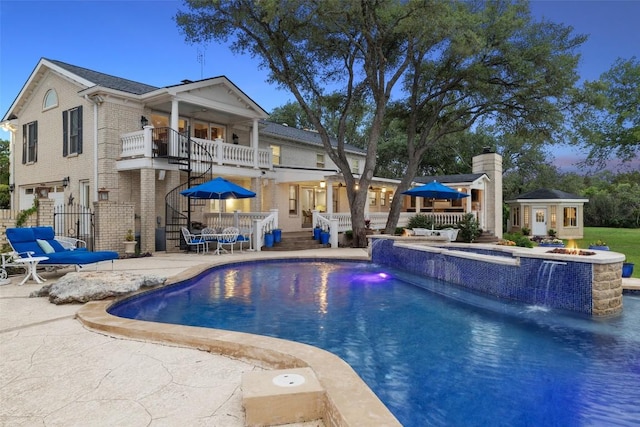 17700 N Rim Dr, Leander, TX 78641 - view of pool with a patio, an outdoor fire pit, an outdoor structure, stairway, and a pool with connected hot tub