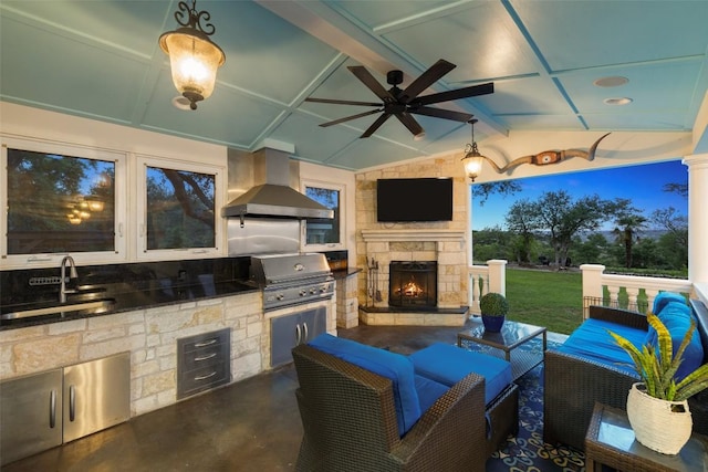 view of patio / terrace featuring a sink, a grill, a ceiling fan, exterior kitchen, and an outdoor living space with a fireplace