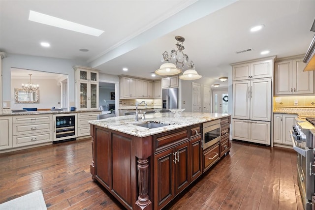 17700 N Rim Dr, Leander, TX 78641 - kitchen featuring wine cooler, built in appliances, backsplash, dark wood-type flooring, and crown molding