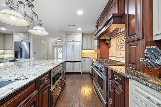 17700 N Rim Dr, Leander, TX 78641 - kitchen featuring built in appliances, light stone counters, recessed lighting, dark wood-style flooring, and custom range hood