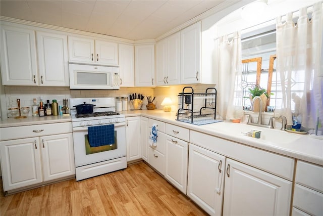 1705 Old Thorndale Rd, Taylor, TX 76574 - kitchen with white appliances, white cabinetry, light countertops, and light wood-type flooring