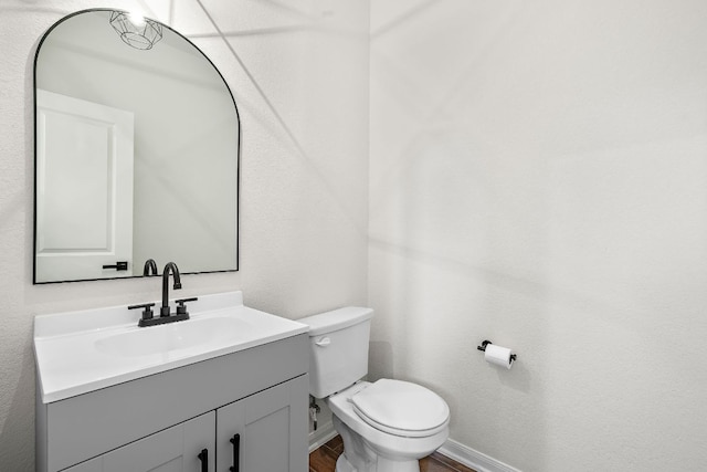 1100 Whipple Tree Trl, Georgetown, TX 78626 - half bath with toilet, vanity, wood finished floors, and baseboards