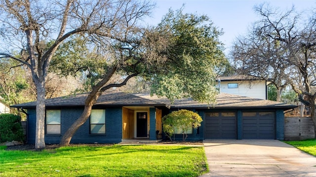 2209 Forest Bend Dr, Austin, TX 78704 - mid-century modern home with driveway, a front lawn, a garage, brick siding, and roof with shingles