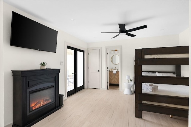 2209 Forest Bend Dr, Austin, TX 78704 - bedroom with light wood-style floors, access to outside, a glass covered fireplace, ensuite bathroom, and a ceiling fan