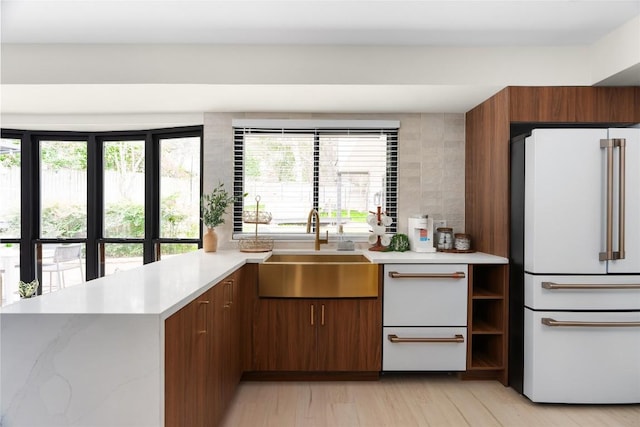 2209 Forest Bend Dr, Austin, TX 78704 - kitchen featuring freestanding refrigerator, light countertops, a peninsula, and healthy amount of natural light
