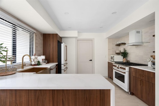 2209 Forest Bend Dr, Austin, TX 78704 - kitchen with white appliances, wall chimney exhaust hood, decorative backsplash, modern cabinets, and light wood-type flooring