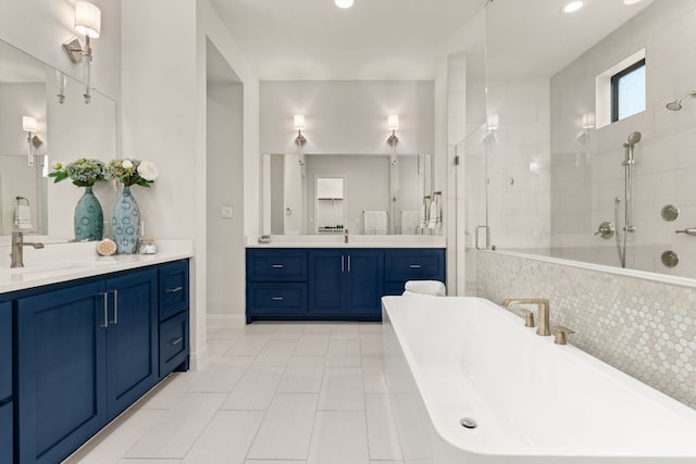 bathroom featuring a shower stall, a soaking tub, two vanities, tile patterned floors, and recessed lighting