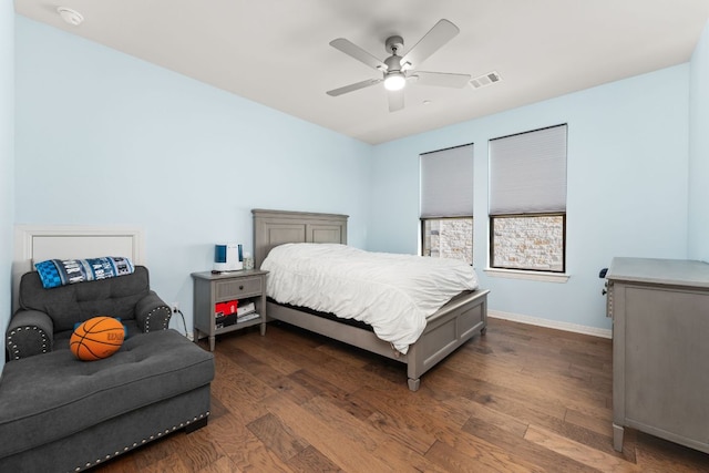 bedroom with dark wood-style flooring, baseboards, and a ceiling fan