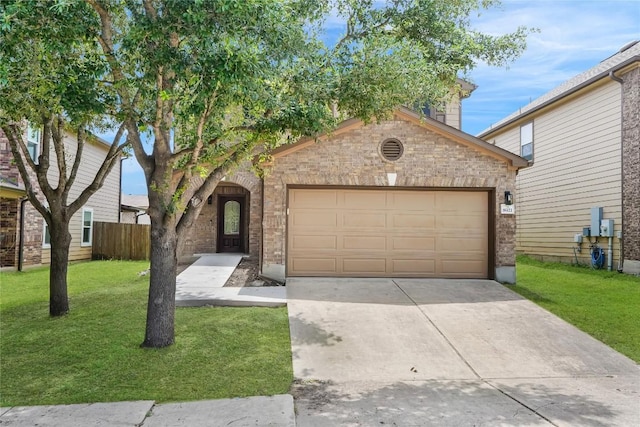 8921 Norwich Castle, Austin, TX 78747 - view of front of house with a front lawn, concrete driveway, an attached garage, and brick siding