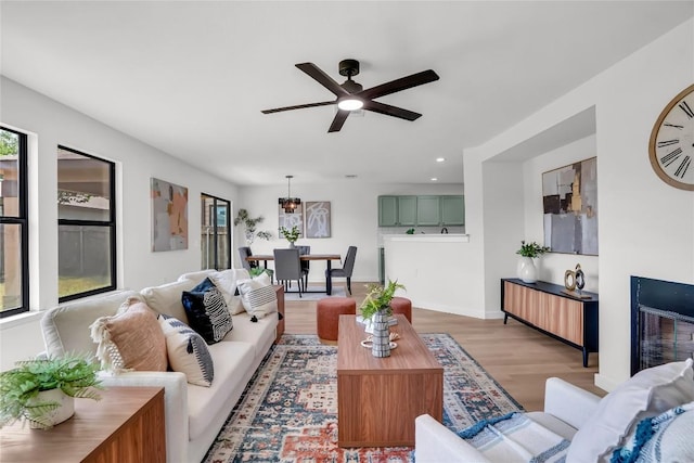 8921 Norwich Castle, Austin, TX 78747 - living area featuring light wood-style flooring, a ceiling fan, recessed lighting, and baseboards