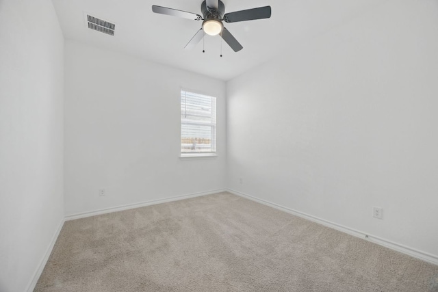 spare room with carpet flooring, baseboards, and ceiling fan