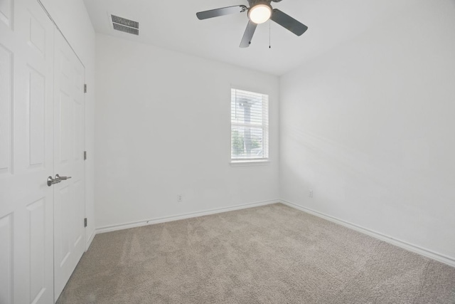 unfurnished room featuring carpet flooring, a ceiling fan, and baseboards