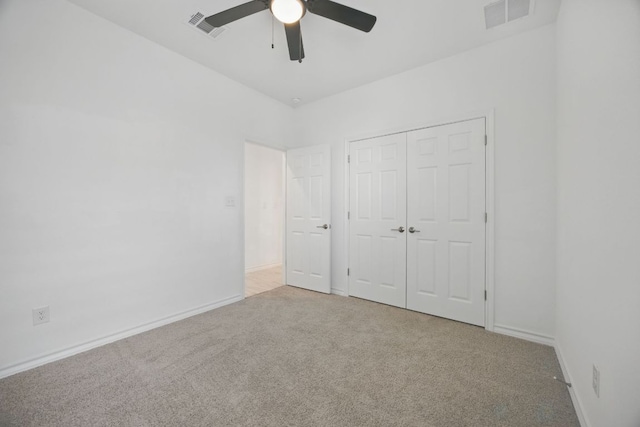 unfurnished bedroom featuring carpet flooring, a closet, a ceiling fan, and baseboards