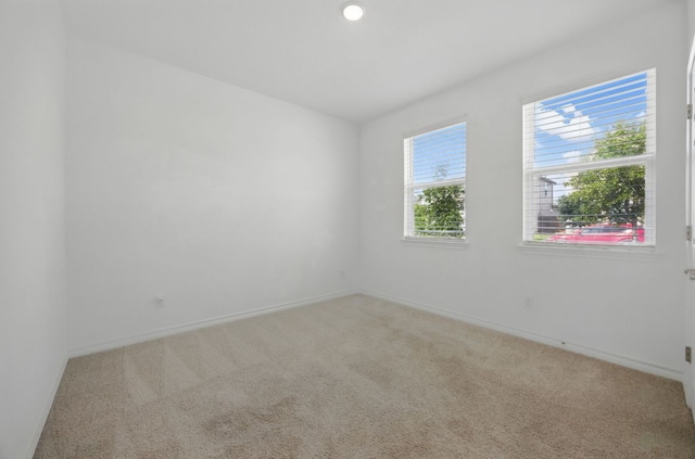 empty room featuring carpet flooring and baseboards