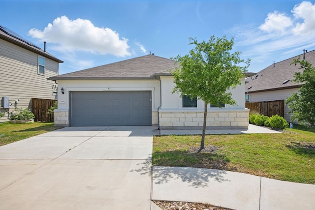 view of front of house featuring a garage, concrete driveway, stucco siding, and stone siding