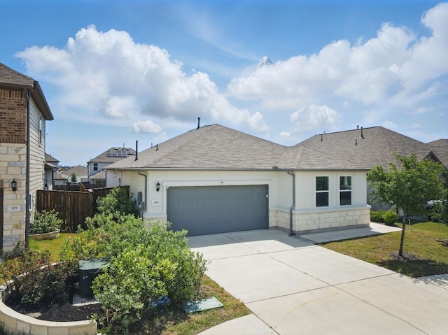 view of front of property featuring an attached garage, concrete driveway, roof with shingles, stone siding, and stucco siding