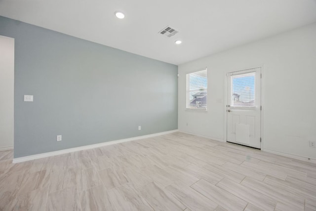 spare room featuring baseboards and recessed lighting