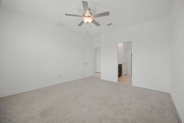 unfurnished bedroom with light carpet, baseboards, and a ceiling fan