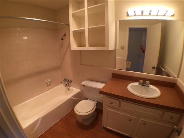 2404 Longview St Unit 205, Austin, TX 78705 - bathroom with shower / bath combination, toilet, wood finished floors, and vanity