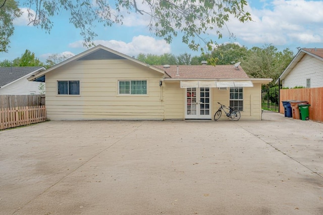 9801 Oriole Dr, Austin, TX 78753 - rear view of property featuring a patio, concrete driveway, and french doors