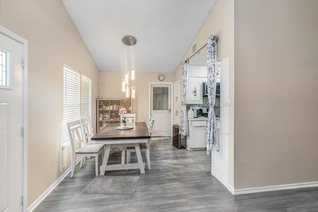 9801 Oriole Dr, Austin, TX 78753 - dining space featuring vaulted ceiling, wood finished floors, and baseboards