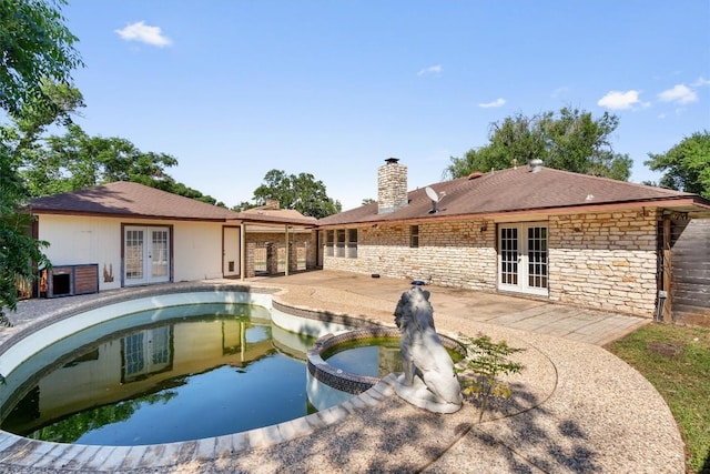 7008 Beckett Rd, Austin, TX 78749 - view of swimming pool with french doors, a pool with connected hot tub, and a patio