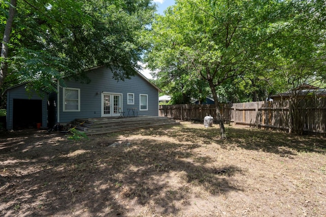 716 W 35th St, Austin, TX 78705 - view of yard featuring french doors, a wooden deck, and a garage