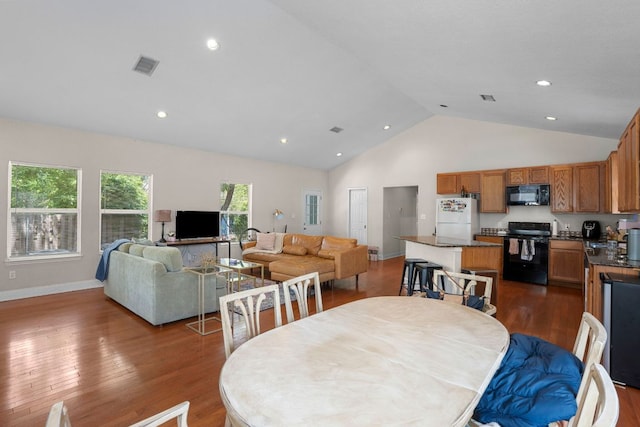 dining room with dark wood-style floors, high vaulted ceiling, baseboards, and recessed lighting