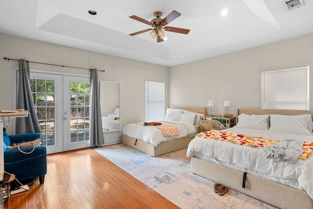 716 W 35th St, Austin, TX 78705 - bedroom featuring access to exterior, french doors, wood-type flooring, a tray ceiling, and recessed lighting