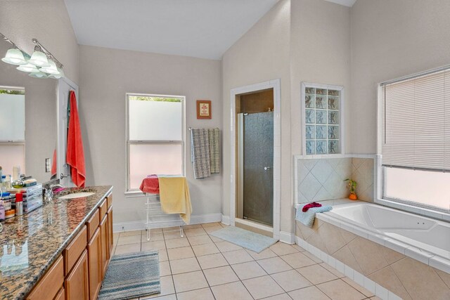716 W 35th St, Austin, TX 78705 - full bath featuring tile patterned flooring, vanity, a bath, a shower stall, and lofted ceiling