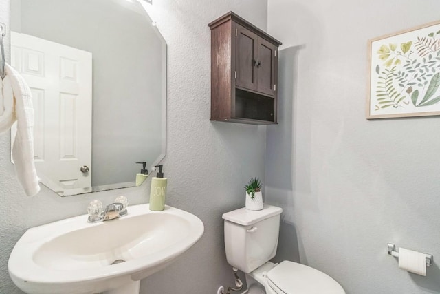 bathroom with a sink and toilet