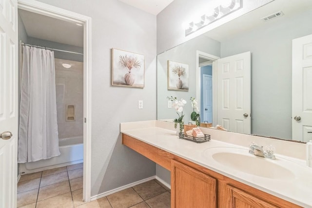 bathroom with vanity, baseboards, tile patterned flooring, and shower / bath combo