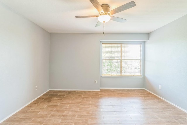 empty room with ceiling fan, baseboards, and light wood-style flooring