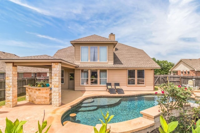 back of house featuring a fenced backyard, a patio, a chimney, and roof with shingles