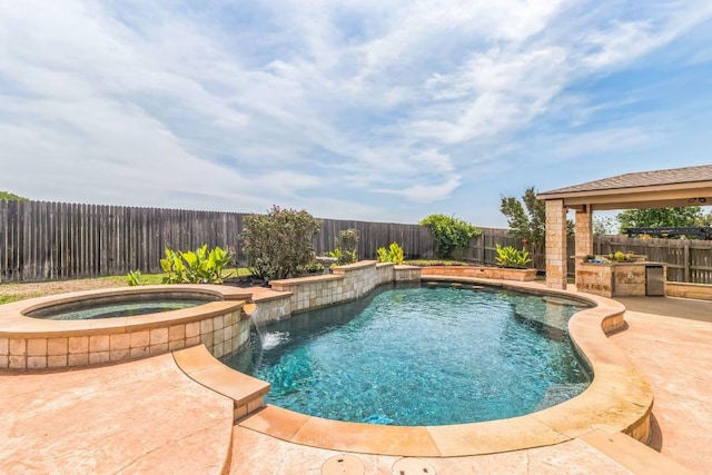 view of swimming pool featuring a fenced backyard, a patio area, and a pool with connected hot tub