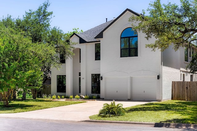 6909 Larue Belle Cv, Austin, TX 78739 - french country home featuring brick siding, driveway, an attached garage, and roof with shingles