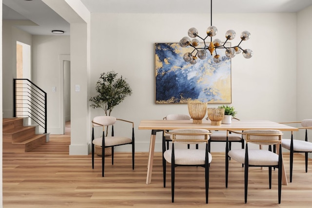 6909 Larue Belle Cv, Austin, TX 78739 - dining space with light wood-style flooring, stairway, baseboards, and a chandelier