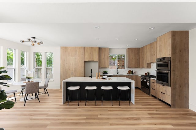 6909 Larue Belle Cv, Austin, TX 78739 - kitchen featuring stainless steel appliances, modern cabinets, light wood-style flooring, and recessed lighting