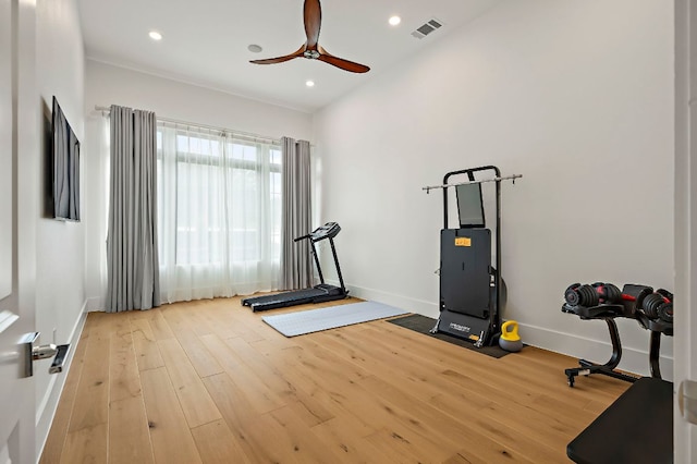 exercise room featuring wood finished floors, ceiling fan, baseboards, and recessed lighting