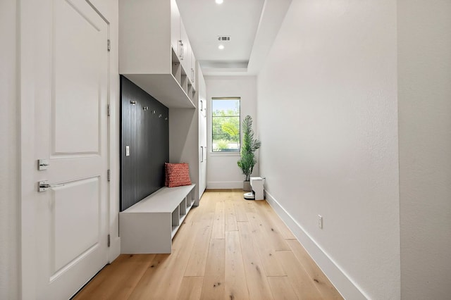 mudroom with light wood finished floors, baseboards, and recessed lighting