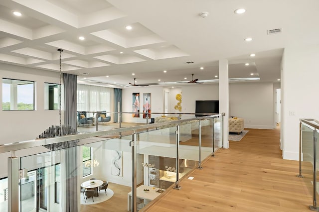 corridor featuring recessed lighting, light wood finished floors, coffered ceiling, beamed ceiling, and baseboards