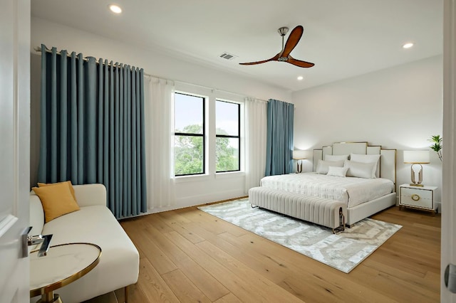 bedroom with wood finished floors, recessed lighting, and a ceiling fan