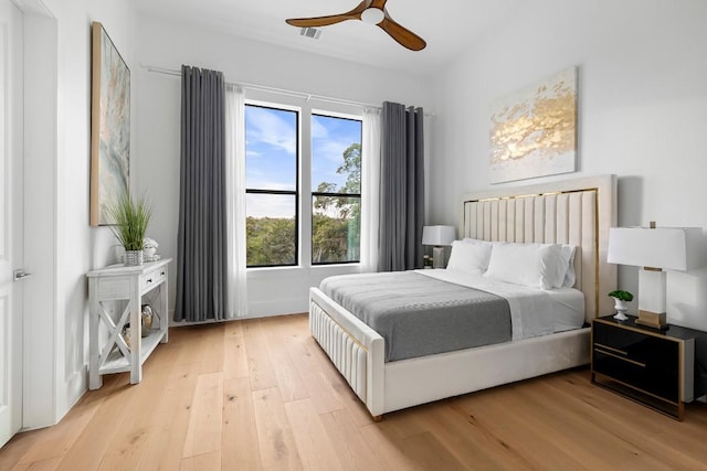 bedroom featuring light wood-type flooring and a ceiling fan