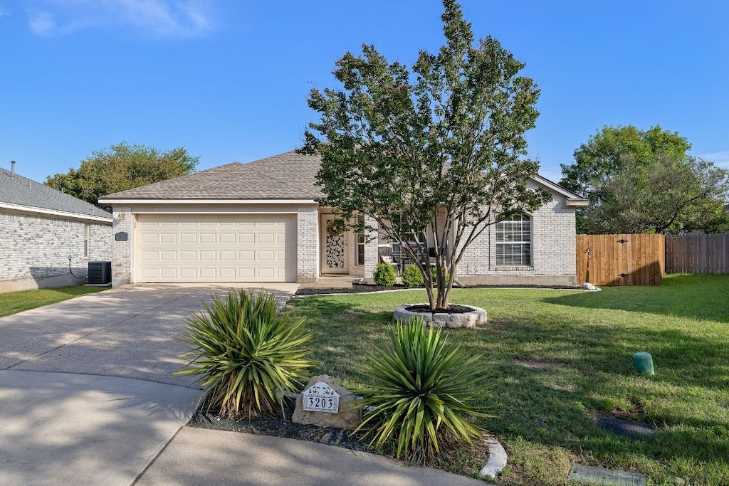 3203 Tenaza Cv, Round Rock, TX 78664 - view of front of property with driveway, an attached garage, brick siding, and cooling unit