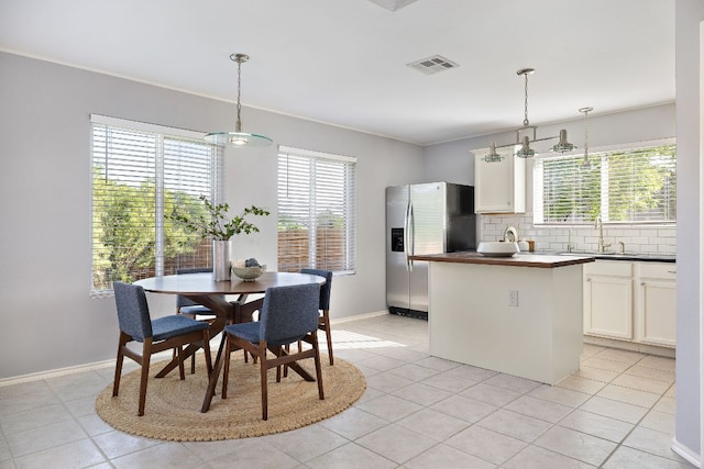dining space with light tile patterned floors and baseboards
