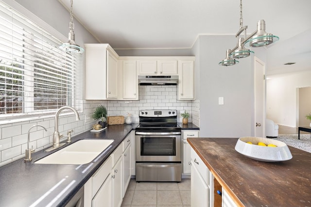kitchen featuring stainless steel range with electric cooktop, under cabinet range hood, a sink, tasteful backsplash, and white cabinetry