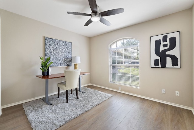 office with wood finished floors, a ceiling fan, and baseboards