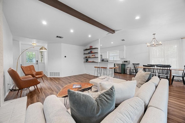 living area with a chandelier, wood finished floors, recessed lighting, and baseboards